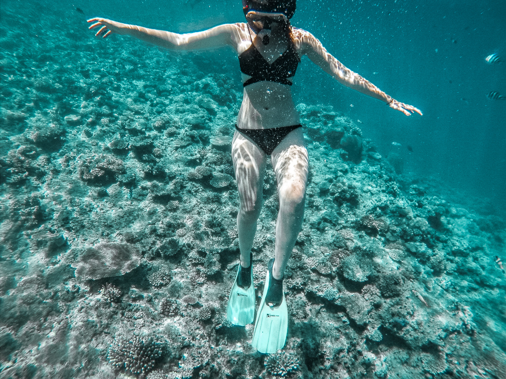 A woman snorkelling at a coral reef