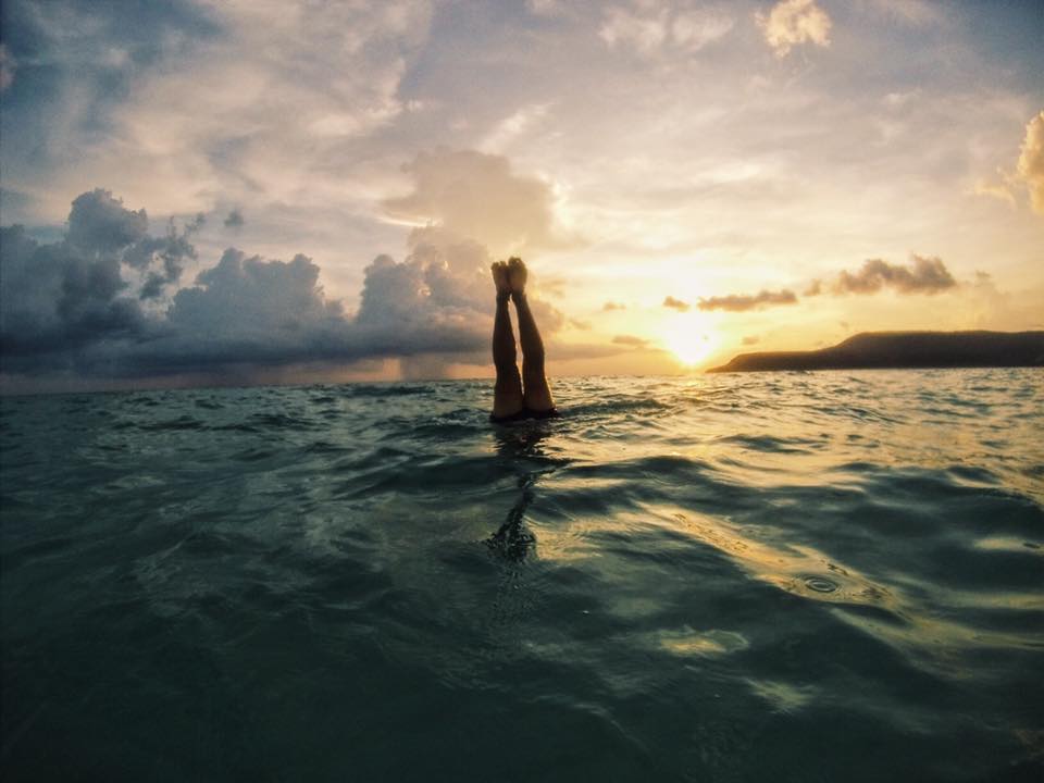 Phil doing handstands at sunset in the sea on Koh Rong Island